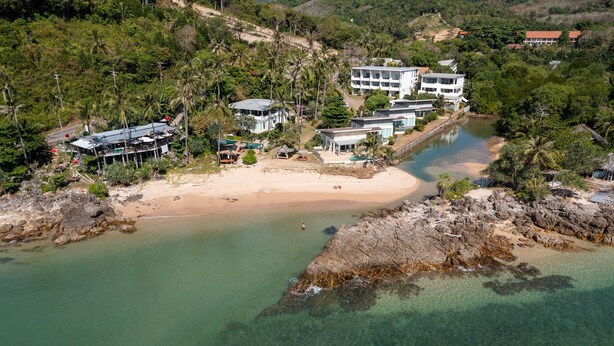 An aerial view of a coastal property with a beach, clear waters, and a large building with multiple floors. - Exclusive beach apartment with Wonderful View (Ko Lanta Yai)