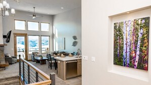 A spacious living area with a kitchen, large windows, and a dining area. - Adventure Awaits at R202 | Ridge Haven in Eden, UT! (Eden)