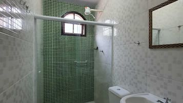 A bathroom with a toilet, bidet, and sink.