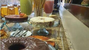 A buffet setup with various food items and drinks.