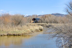Escape to a serene riverside retreat surrounded by natural beauty and rolling hills.