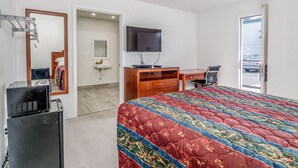 A hotel room with a bed, a desk, a chair, a television, a mirror, and a wardrobe. - The Alameda Motel San Jose (San Jose)