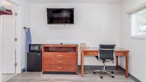 A room with a wooden desk, a chair, a television mounted on the wall, and a small kitchenette area. - The Alameda Motel San Jose (San Jose)