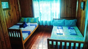 A room with two wooden beds, a wooden chair, and a window with lace curtains. - ROOMS AT AN AMERICAN-STYLE CABIN (Sagada)