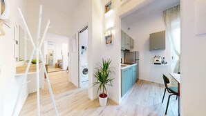A modern apartment with a kitchen, dining area, and a living space. - Four stops from the center of Milan, you will have all the comforts of home! (Milano)