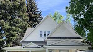 A two-story house with a front porch, a garage, and a covered entryway.