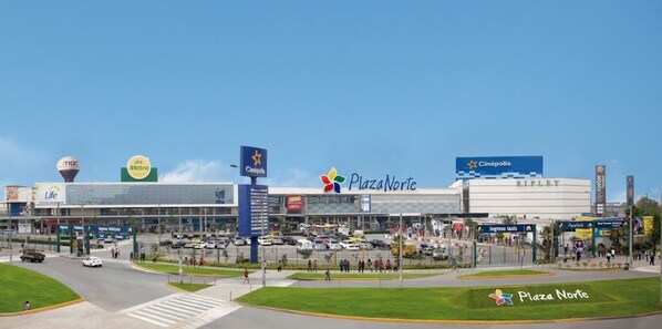 A commercial area with a large building labeled 'Plaza Norte' and 'Ripley'. - HOSPEDAJE ESCORPIO (Lima)