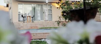 Elegant Poolside Retreat: 2-Bed Luxury Guesthouse
