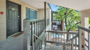 A covered outdoor area with a door marked 204, a welcome mat, and a staircase leading to a second level. - Sedona Eve

 (Sedona)