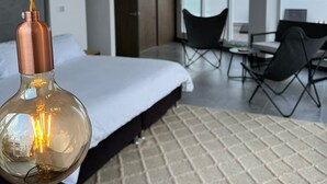 A modern hotel room with a large bed, a desk, and two hanging pendant lights. - Cartagena Morros Beach and Sea (Cartagena)