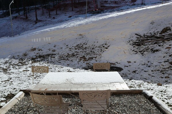 A snow-covered outdoor seating area with a table and chairs. - LES COLCHIQUES N°C208 (LES ORRES 1800)