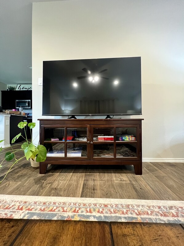 Relax in this cozy living space with a large flat-screen TV and comfortable seating area.