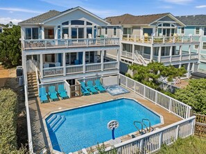 A multi-story building with a pool and outdoor seating. - Wink Beach | Oceanfront | Private Pool, Hot Tub, and Dog Friendly (Nags Head)