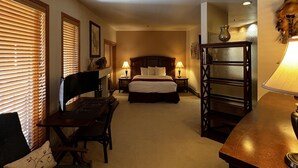 A hotel room with a bed, a desk, a chair, a lamp, and a shelf. - Experience Comfort and Convenience at Kendall 337, 2-bedroom condo in the heart of Purgatory Village (Durango)