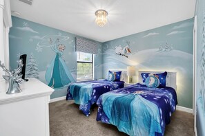 A bedroom with two beds, a chandelier, and a mural of a winter scene. - Splendor Retreat| 6BR Villa w/ Kid's Room & Pool (Davenport)