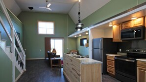 A spacious kitchen with wooden cabinets, a built-in island, and modern appliances.
