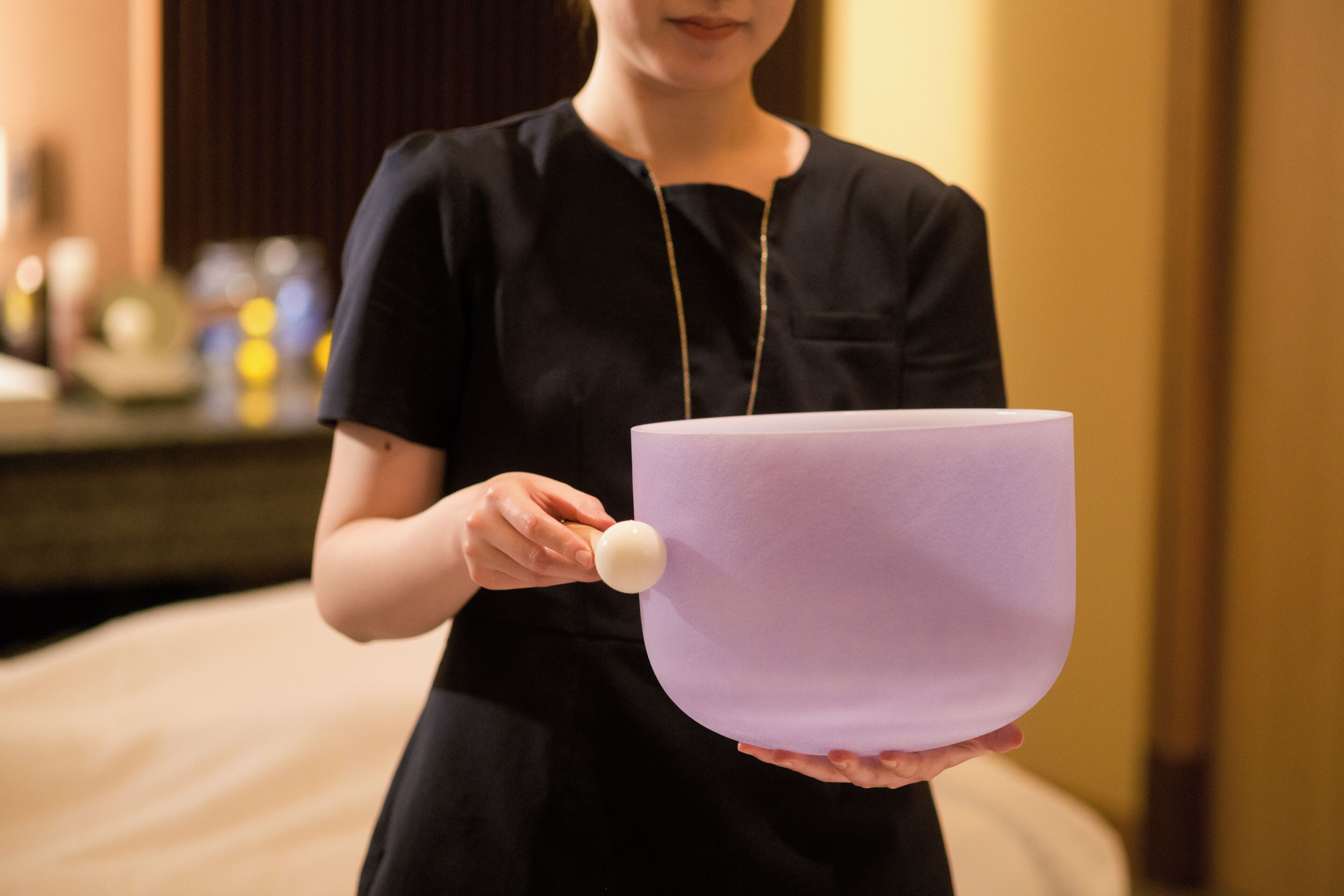 A person holding a large purple object with a round knob.