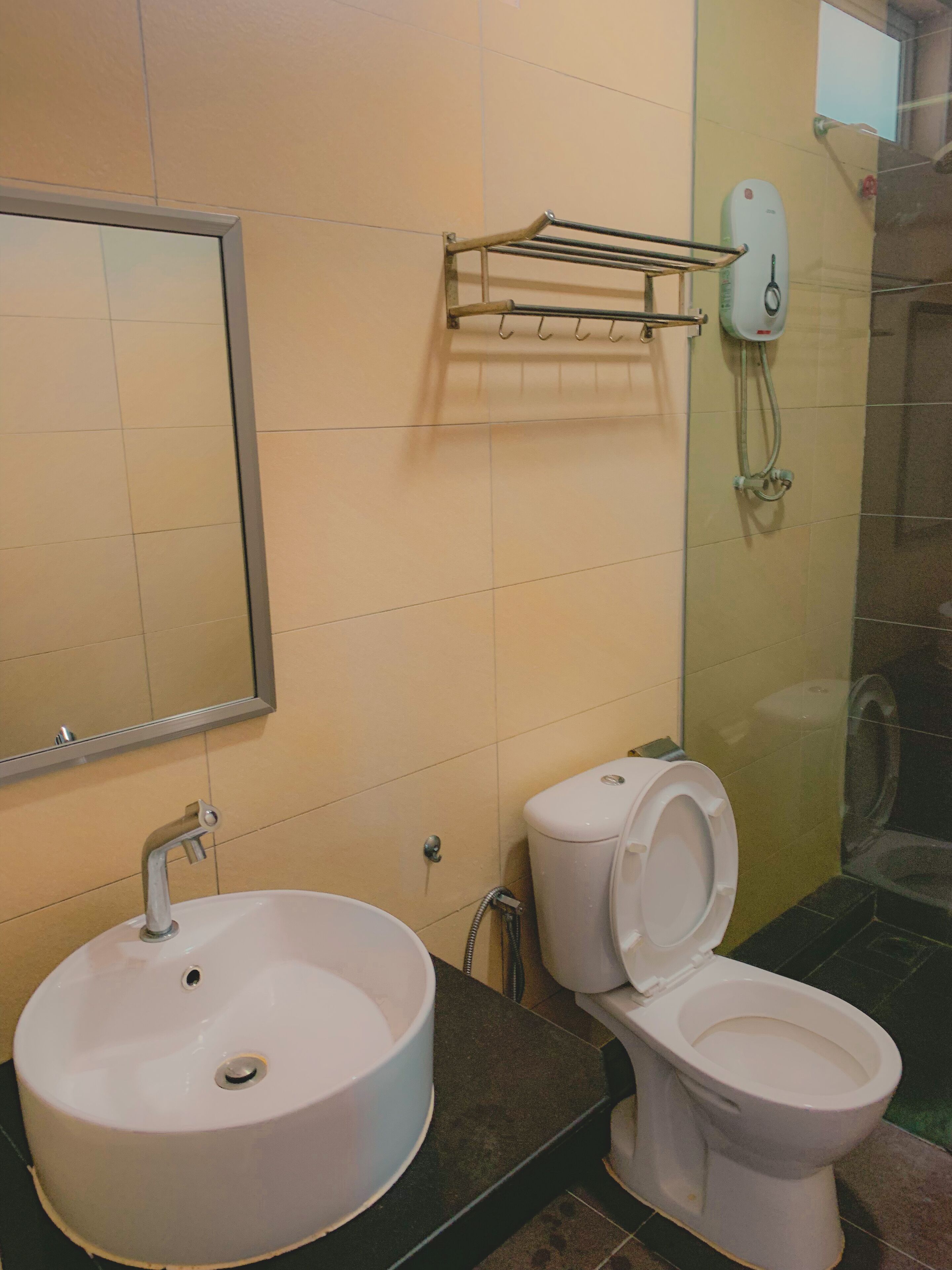 A bathroom with a sink, toilet, and a shower area.