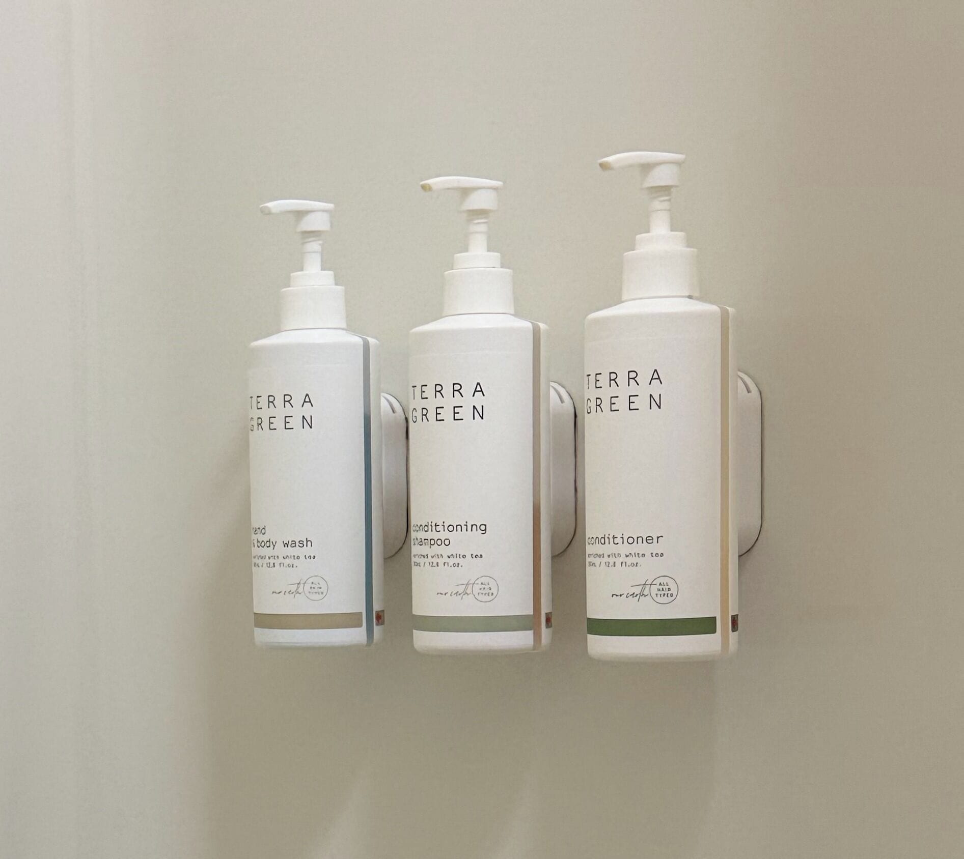 Three white Terra Green bottles on a wall.
