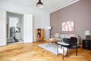 Relax in this stylish living room with a sofa, accent chair, coffee table, and bookshelf.