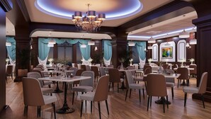 A spacious dining area with multiple tables and chairs, elegant chandeliers, and draped curtains. - Ngoc Thu Palace (Can Tho)