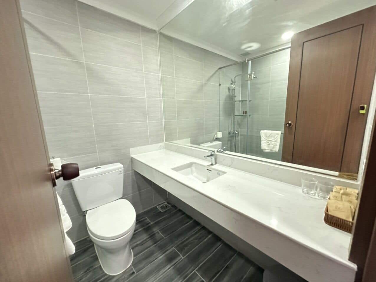 A modern bathroom with a toilet, sink, and shower area.