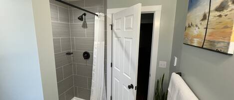 Shower, hair dryer, towels, toilet paper