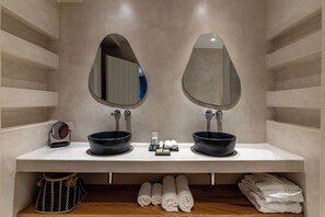 A bathroom with two sinks, mirrors, and towels. - Arotron Santorini (Santorini)