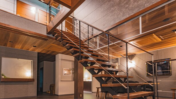 A modern interior with a wooden staircase, a dining area, and a view of the outdoors. - HAOSTAY KAWAGUCHIKO ART MUSEUM. (Fujikawaguchiko)