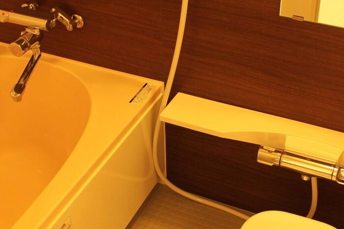 A bathroom with a bathtub, a toilet, and a shower.