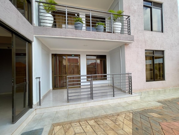 Enjoy the view from the upper-floor balcony with a metal railing and potted plants.