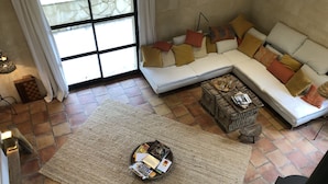 A living room with a sectional sofa, a coffee table, and a rug.