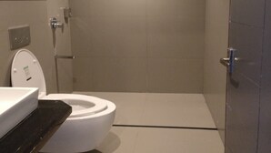 A modern bathroom with a toilet, shower, and sink. - Mist View (Kodaikanal)