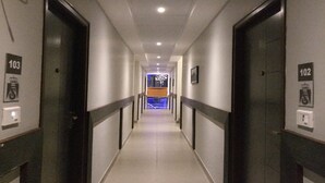 A long, narrow hallway with doors numbered 103 and 102 on either side. - Mist View (Kodaikanal)
