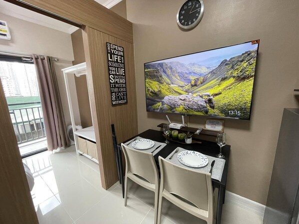 Enjoy meals for two at a dining table with a flat-screen TV and scenic view.