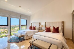 A hotel room with two beds, a large window, a view of the city, and a balcony. - Casa Dos Soles | 3 Bed, 3 Bath (Cabo San Lucas)