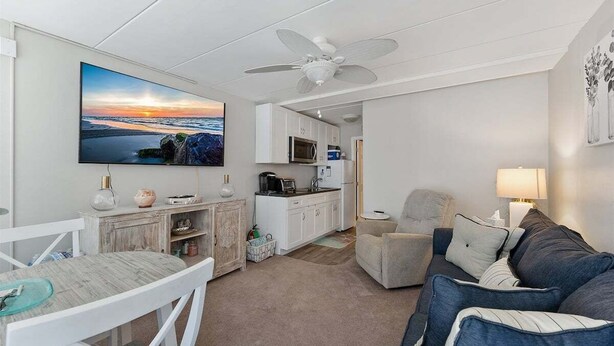 A compact living space with a dining area, kitchenette, and seating area. - Sun, Sand &Poolside Fun! Beautiful 1BR Beach Condo (North Wildwood)
