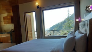 A bedroom with a large bed, a view of a mountain, and a wooden ceiling. - The Jungle Story By Headquarter (Shimla)