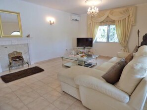 Relax in this stylish living room with a comfortable sofa, coffee table, and fireplace.