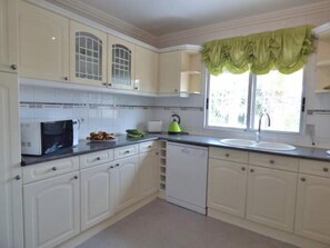 Enjoy a well-equipped kitchen with microwave, kettle, sink, and dishwasher.
