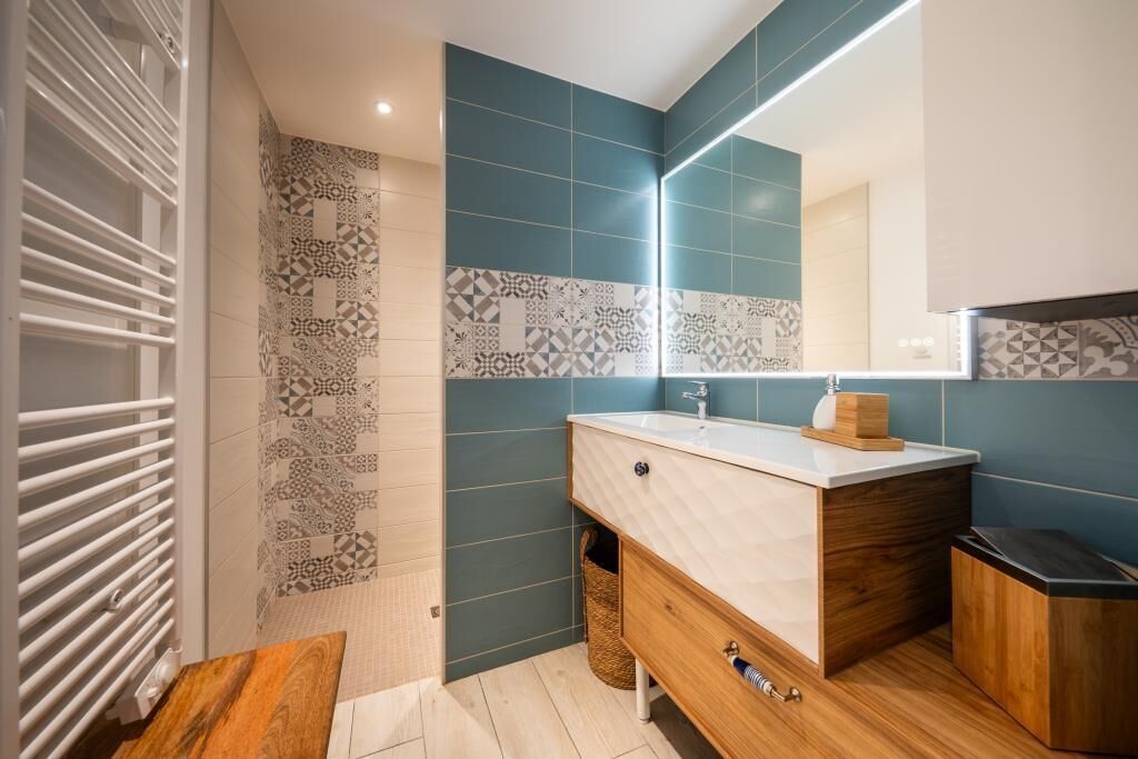 Een moderne badkamer met een houten wastafel, een wastafel en een spiegel.