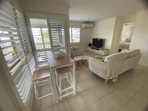 TV, books - Bungalow by the River - Water views, stones throw from River - Pet-Friendly! (Shoalhaven Heads)