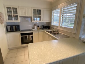Fridge, microwave, oven, stovetop - Bungalow by the River - Water views, stones throw from River - Pet-Friendly! (Shoalhaven Heads)