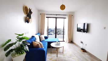 Business Apartment | Living area | 34-inch Smart TV with digital channels