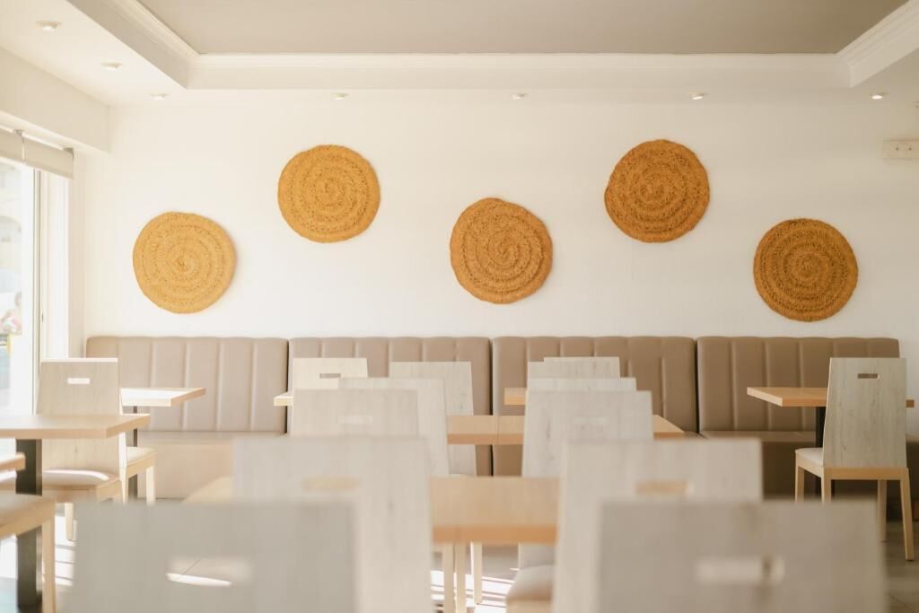 A modern interior with a seating area, tables, and decorative wall art.