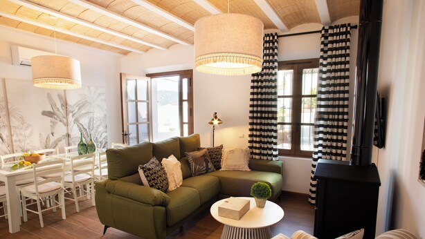 A cozy living room with a sectional sofa, a round coffee table, and a fireplace.