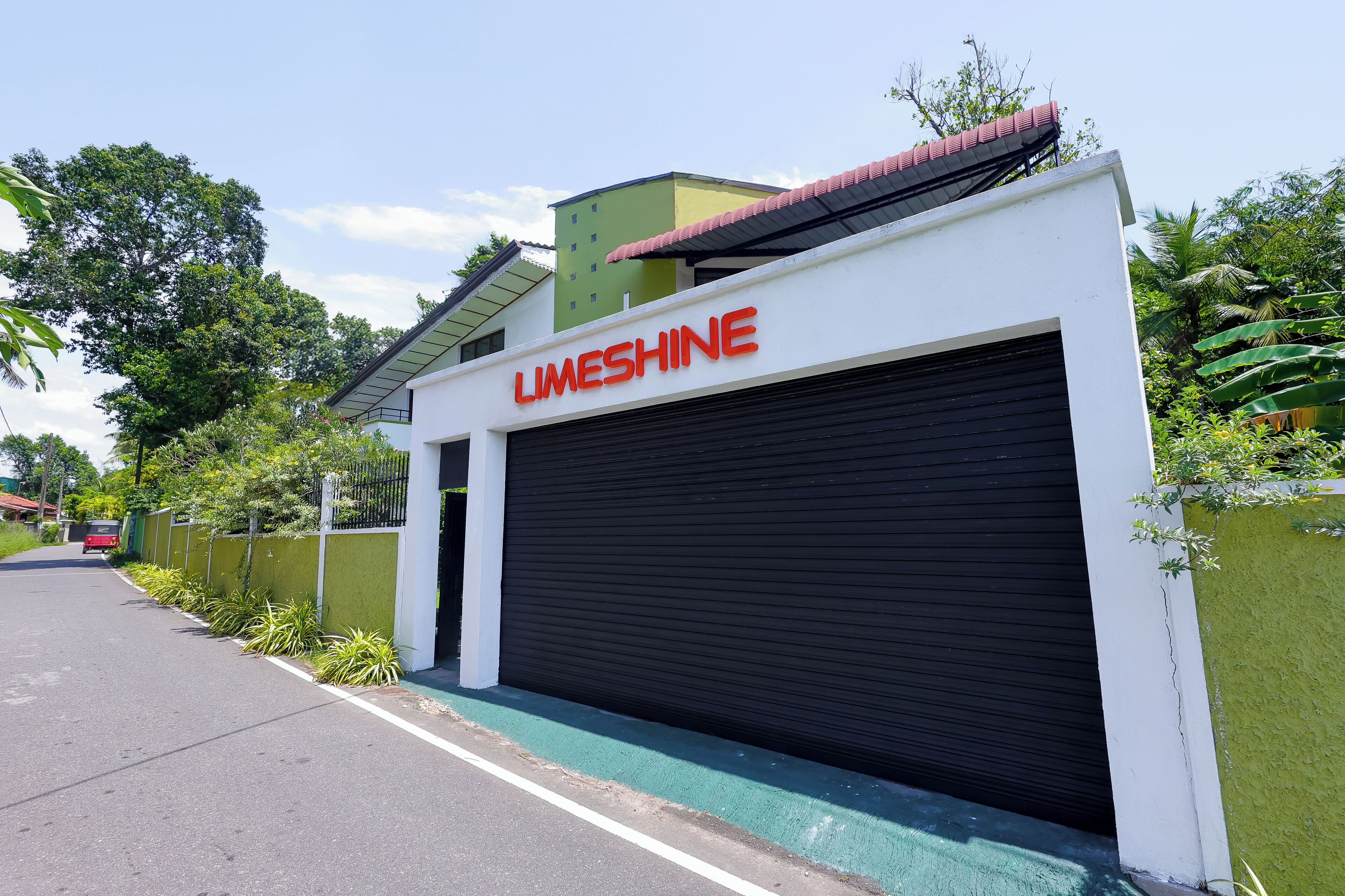 A building with a closed garage door and the name "Limeshine" above it.