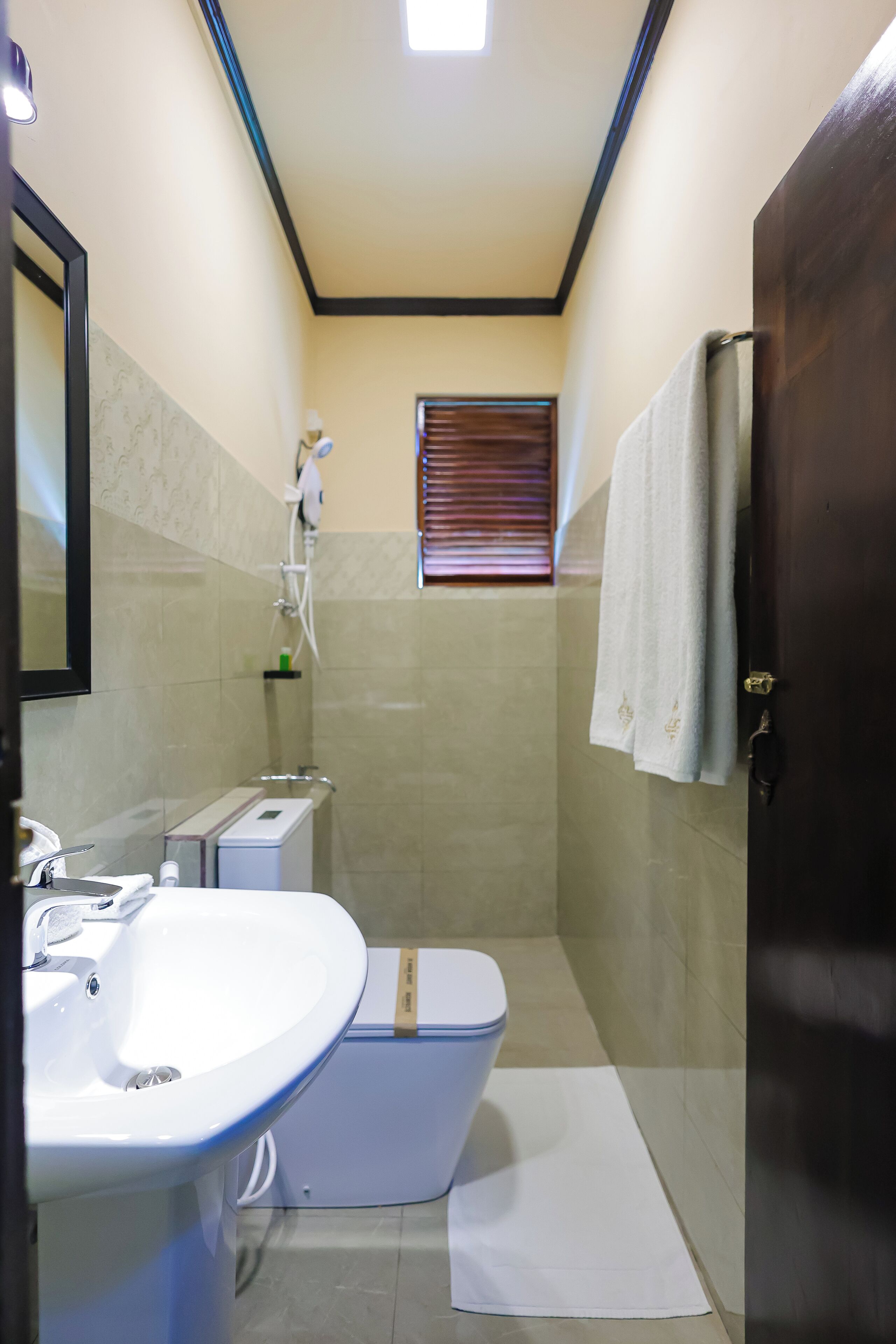 A bathroom with a sink, toilet, and shower.