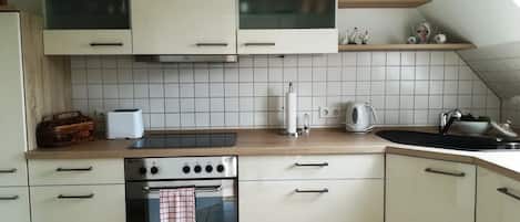 Fridge, stovetop, dishwasher, coffee/tea maker