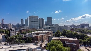 A cityscape with various buildings, including a mix of modern skyscrapers and older structures. - Loft Style Spacious Lux Apt 203, sleeps 6 (Atlanta)